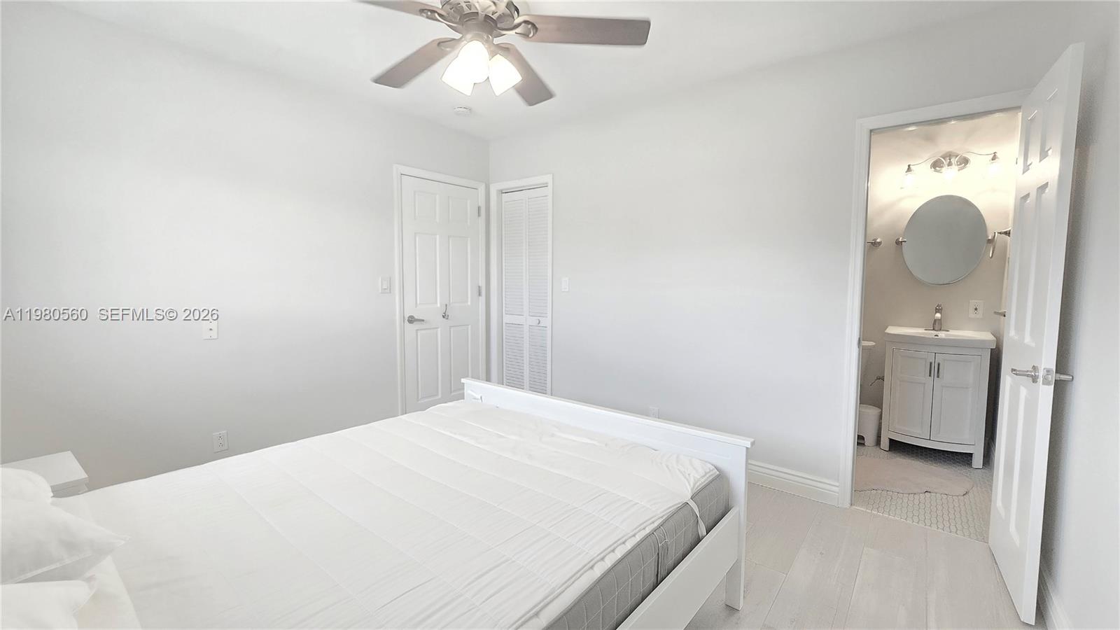 909 Southwest 9th Avenue Boca Raton, FL 33486 - Photo 11 of 18 a bedroom with a bed and a chandelier