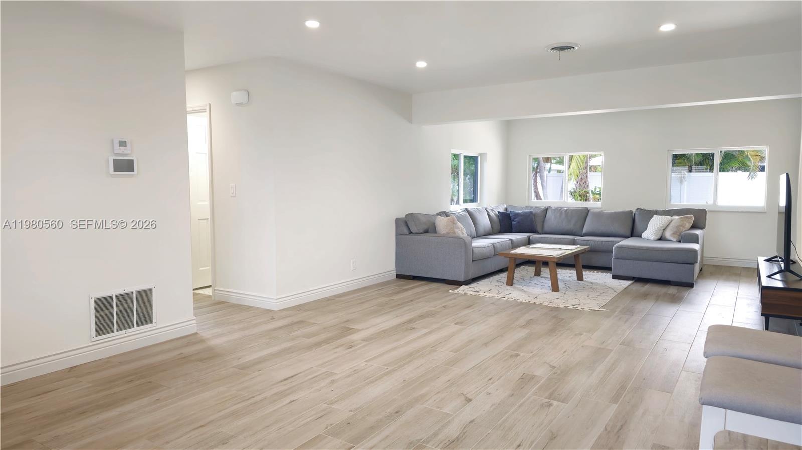 909 Southwest 9th Avenue Boca Raton, FL 33486 - Photo 12 of 18 a living room with furniture and a wooden floor