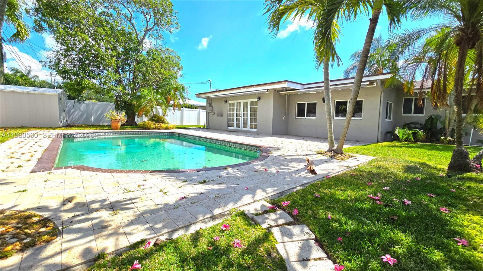 909 Southwest 9th Avenue Boca Raton, FL 33486 - Photo 14 of 18 a view of a house with a swimming pool