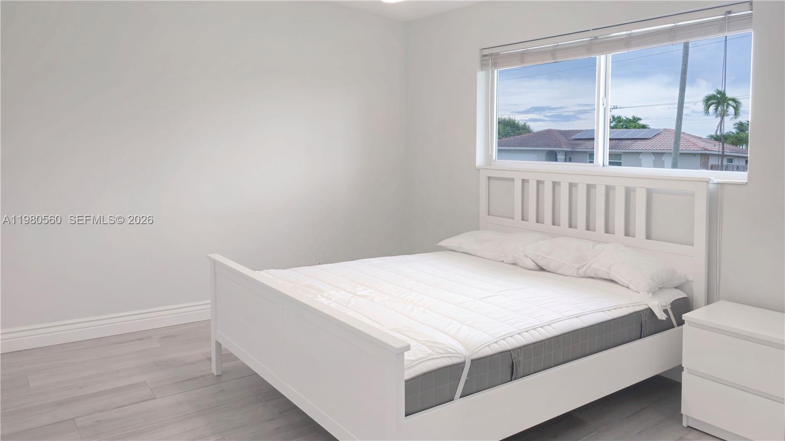 909 Southwest 9th Avenue Boca Raton, FL 33486 - Photo 16 of 18 a bedroom with a bed and a window