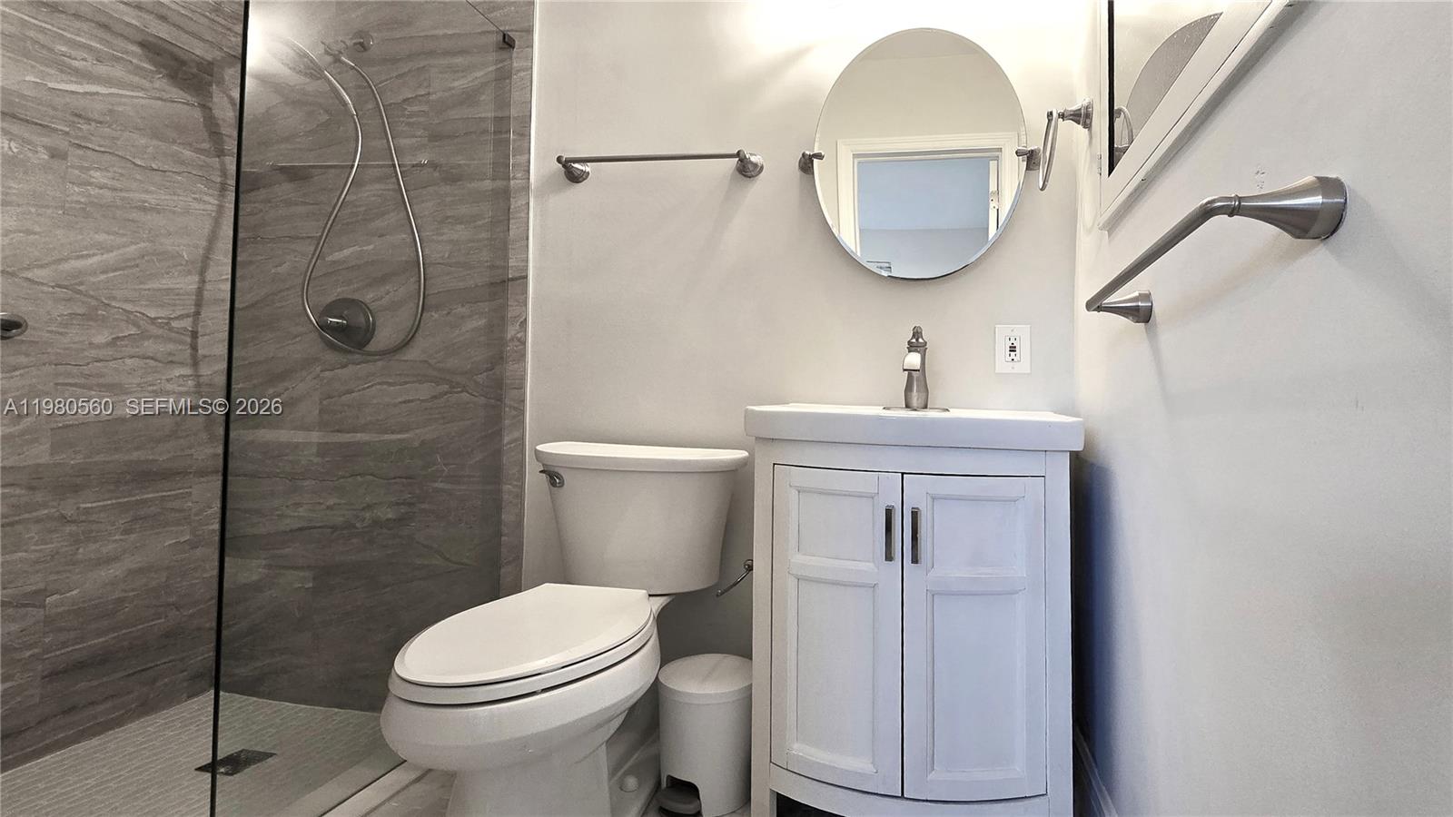 909 Southwest 9th Avenue Boca Raton, FL 33486 - Photo 17 of 18 a bathroom with a sink toilet and a mirror