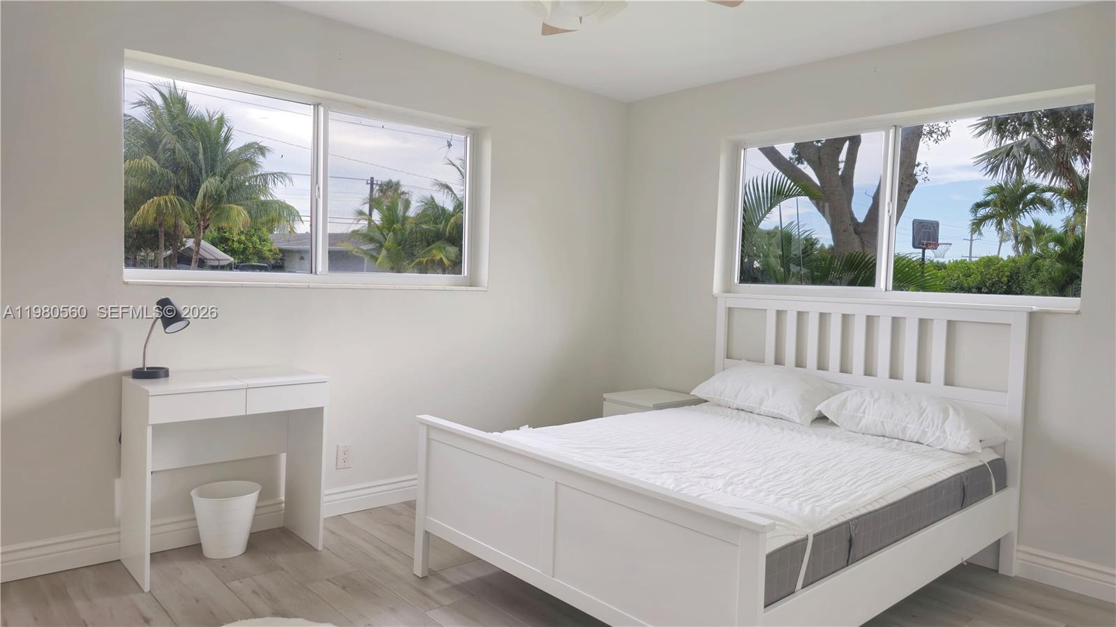 909 Southwest 9th Avenue Boca Raton, FL 33486 - Photo 6 of 18 a bedroom with a bed and a painting on the wall