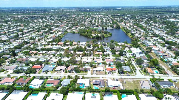 an aerial view of residential houses with city view