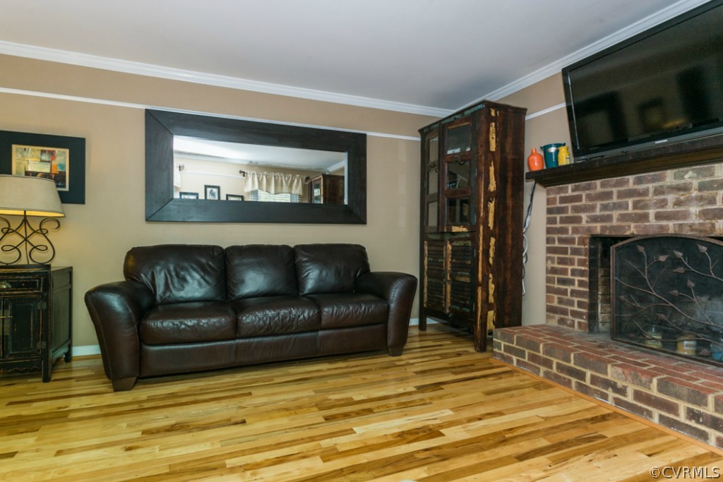 7725 Valencia Road Chesterfield, VA 23832 - Photo 8 of 24 a living room with furniture a flat screen tv and a fireplace