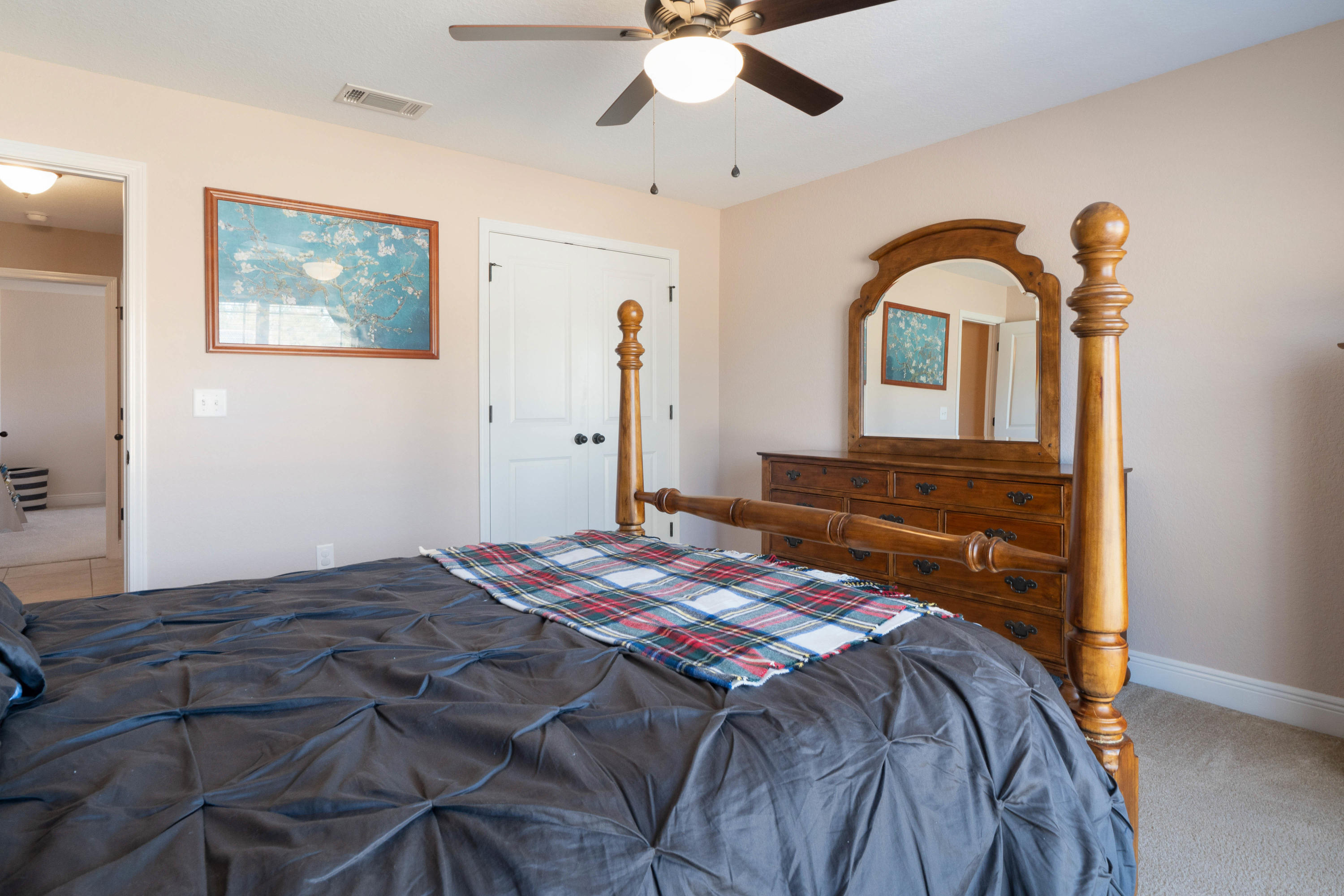 9935 Nichols Lake Road Milton, FL 32583 - Photo 20 of 40 a bedroom with a bed and a chandelier