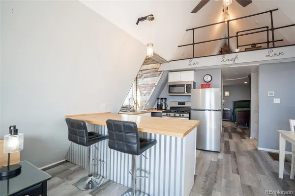 a kitchen with a stove a refrigerator and a sink