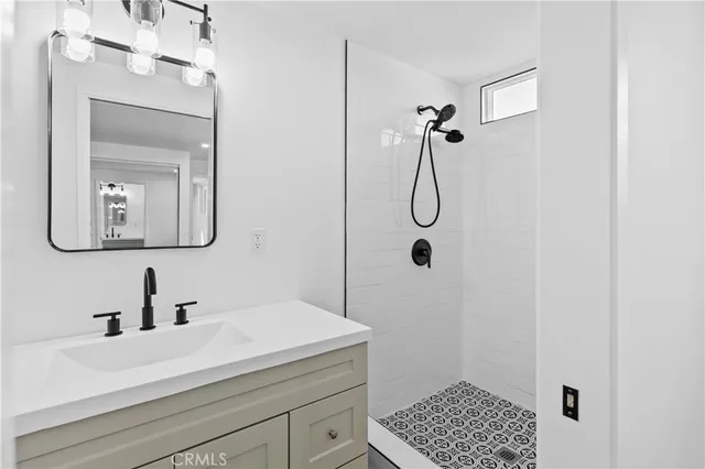 a bathroom with a sink a light fixture and a mirror