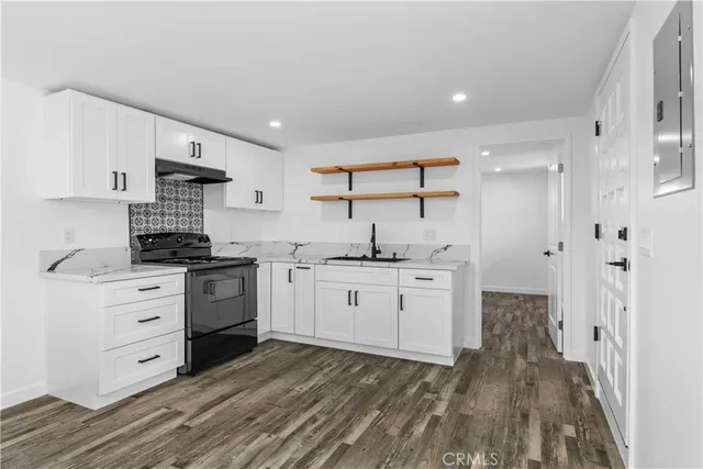 a kitchen with a sink stove and cabinets