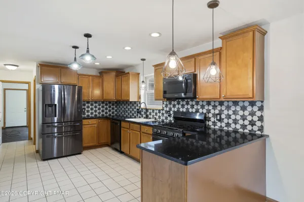 a kitchen with stainless steel appliances granite countertop a sink and cabinets