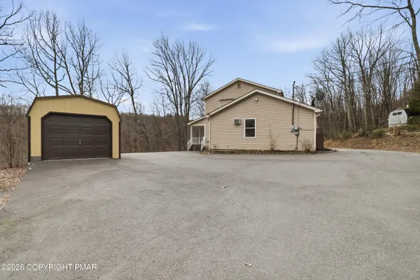 a view of garage and a yard