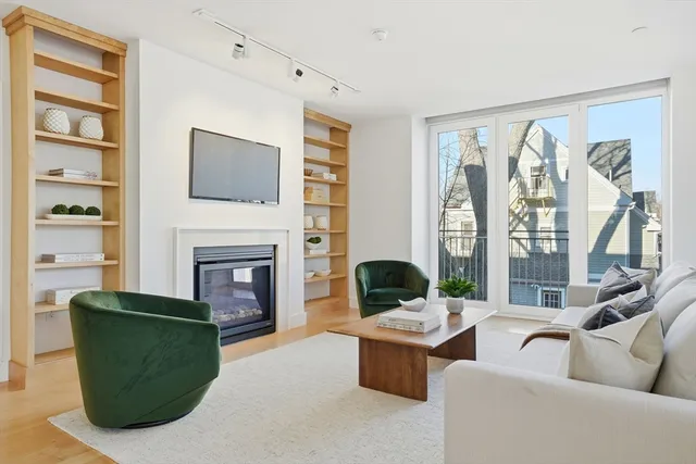 a living room with furniture large window and fireplace