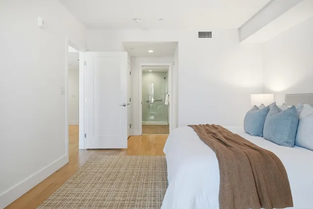 a bedroom with a bed and a mirror