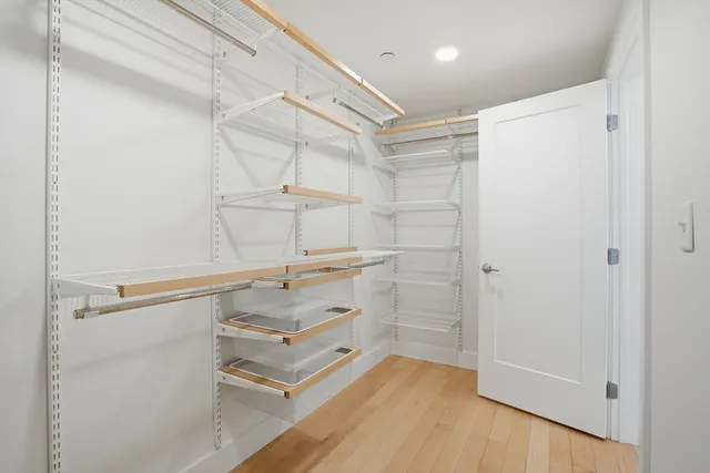 a view of walk in closet with empty racks