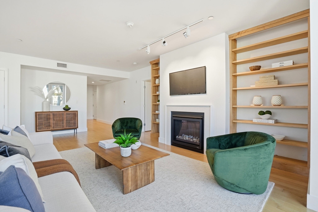 7 Beech Street, Unit 211 Cambridge, MA 02140 - Photo 2 of 17 a living room with furniture and a fireplace
