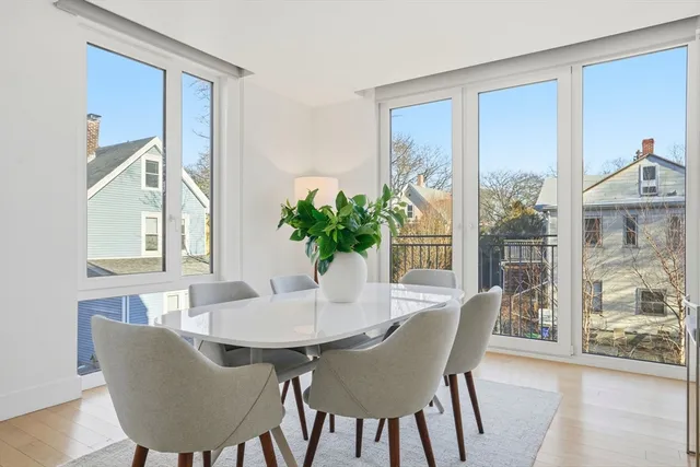 a dining room with furniture window and wooden floor