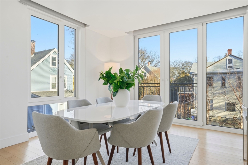 7 Beech Street, Unit 211 Cambridge, MA 02140 - Photo 5 of 17 a dining room with furniture window and wooden floor