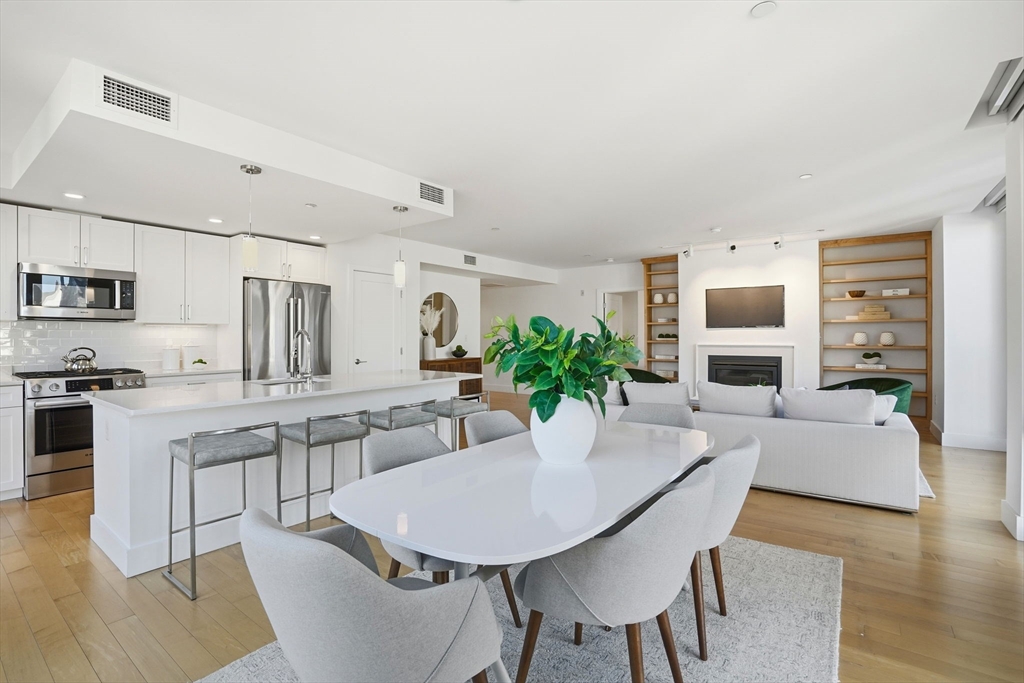 7 Beech Street, Unit 211 Cambridge, MA 02140 - Photo 6 of 17 a view of a dining room with furniture and wooden floor