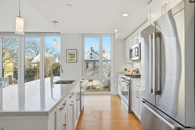 a view of a hallway with furniture and chandelier