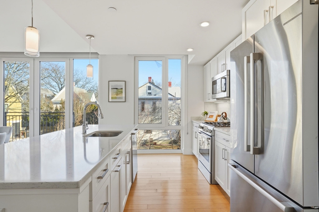 7 Beech Street, Unit 211 Cambridge, MA 02140 - Photo 8 of 17 a view of a hallway with furniture and chandelier