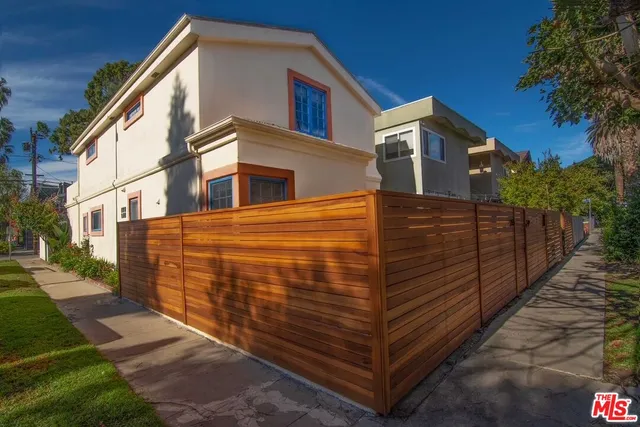a view of a large building with wooden fence
