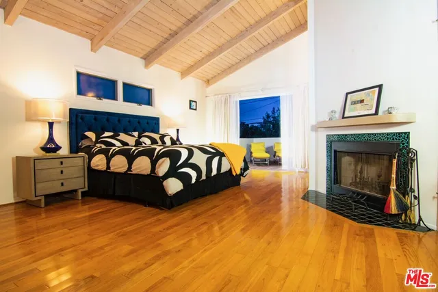 a bedroom with a bed and a fireplace