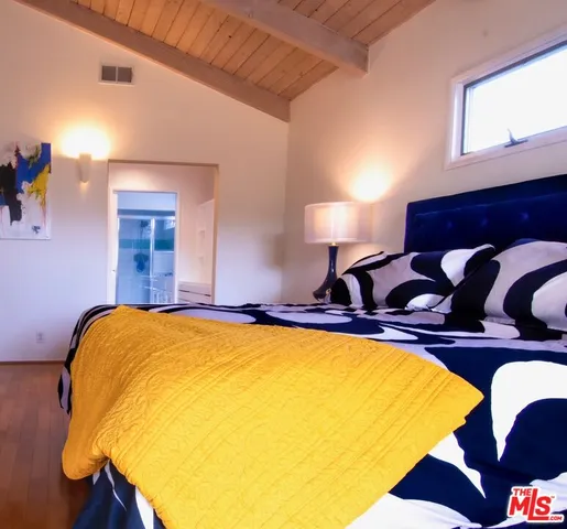 a bed room with a bed and dresser