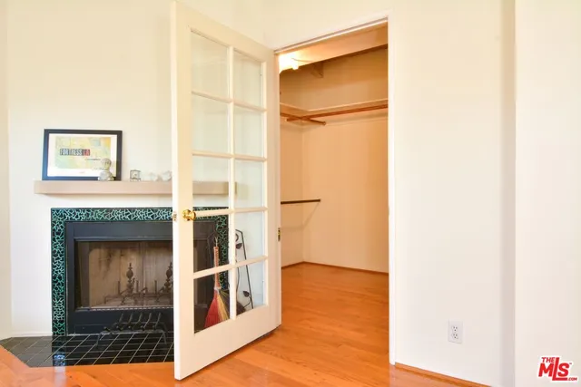 a view of a hallway with wooden floor and front door