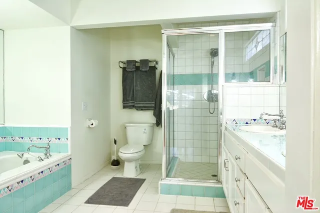 a bathroom with a double vanity sink toilet and shower