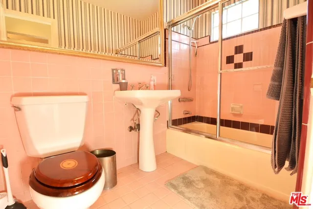 a bathroom with a sink a toilet and a shower