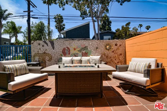 a view of a patio with couches and potted plants