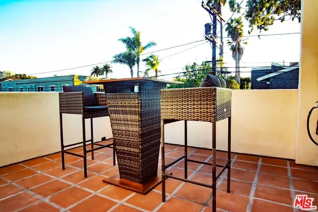a view of a bedroom with wooden floor and a bed