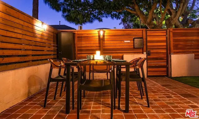 a patio with table and chairs