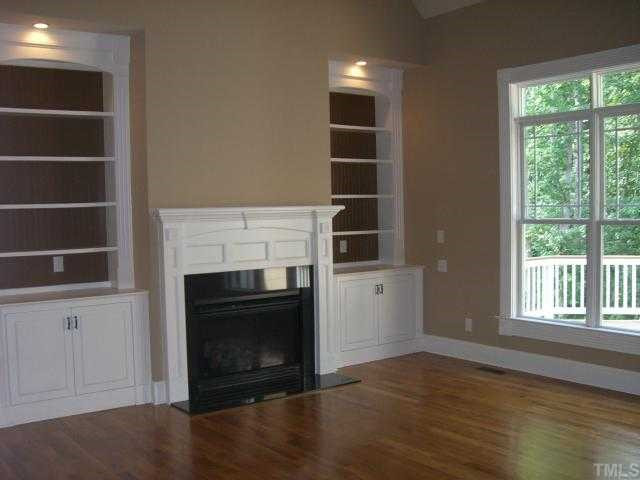 7204 Sparhawk Road Wake Forest, NC 27587 - Photo 5 of 12 Two story living room includes built-ins and gas fireplace.