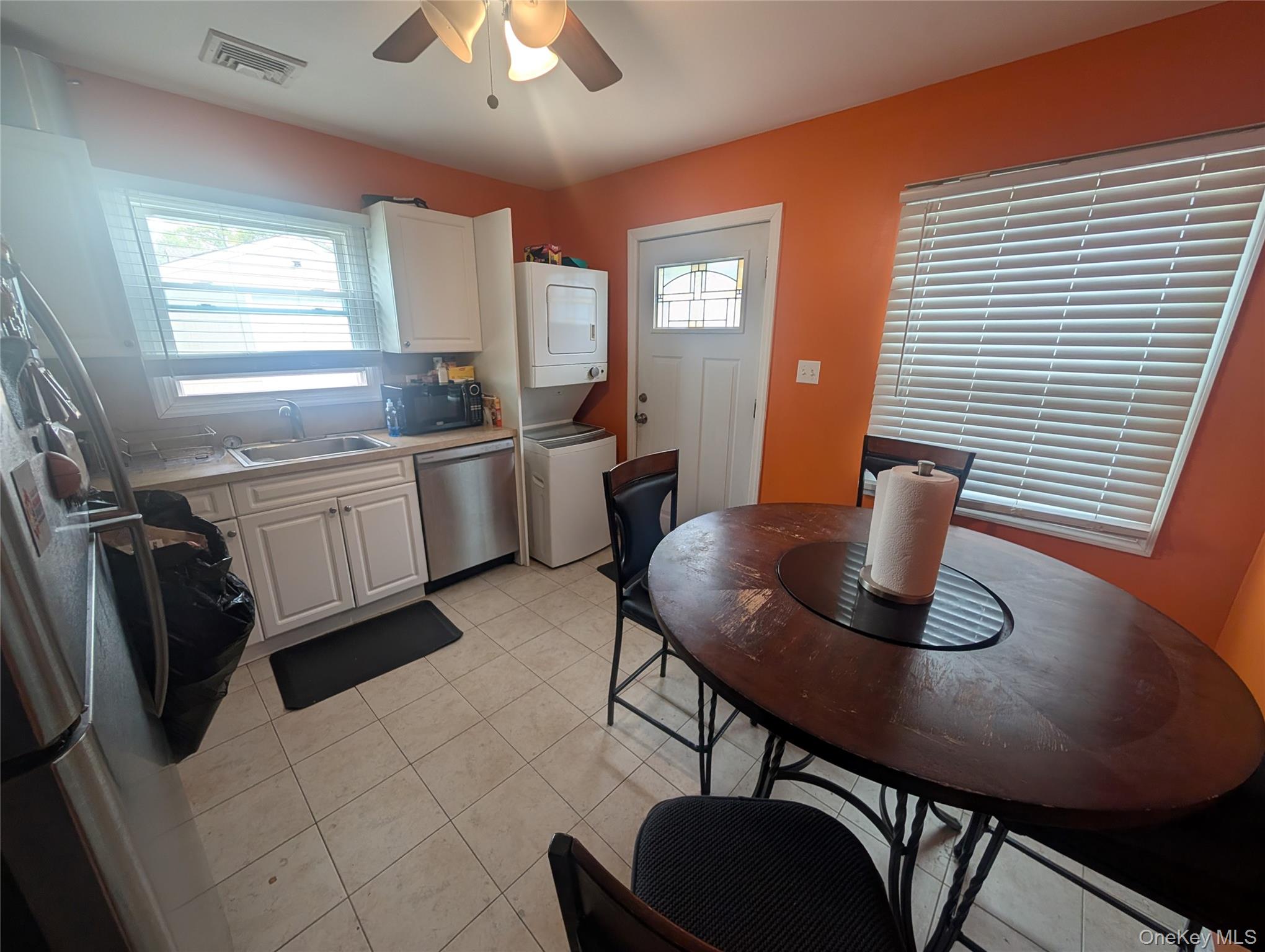 39 State Street Valley Stream, NY 11580 - Photo 2 of 7 a kitchen with a table chairs and refrigerator
