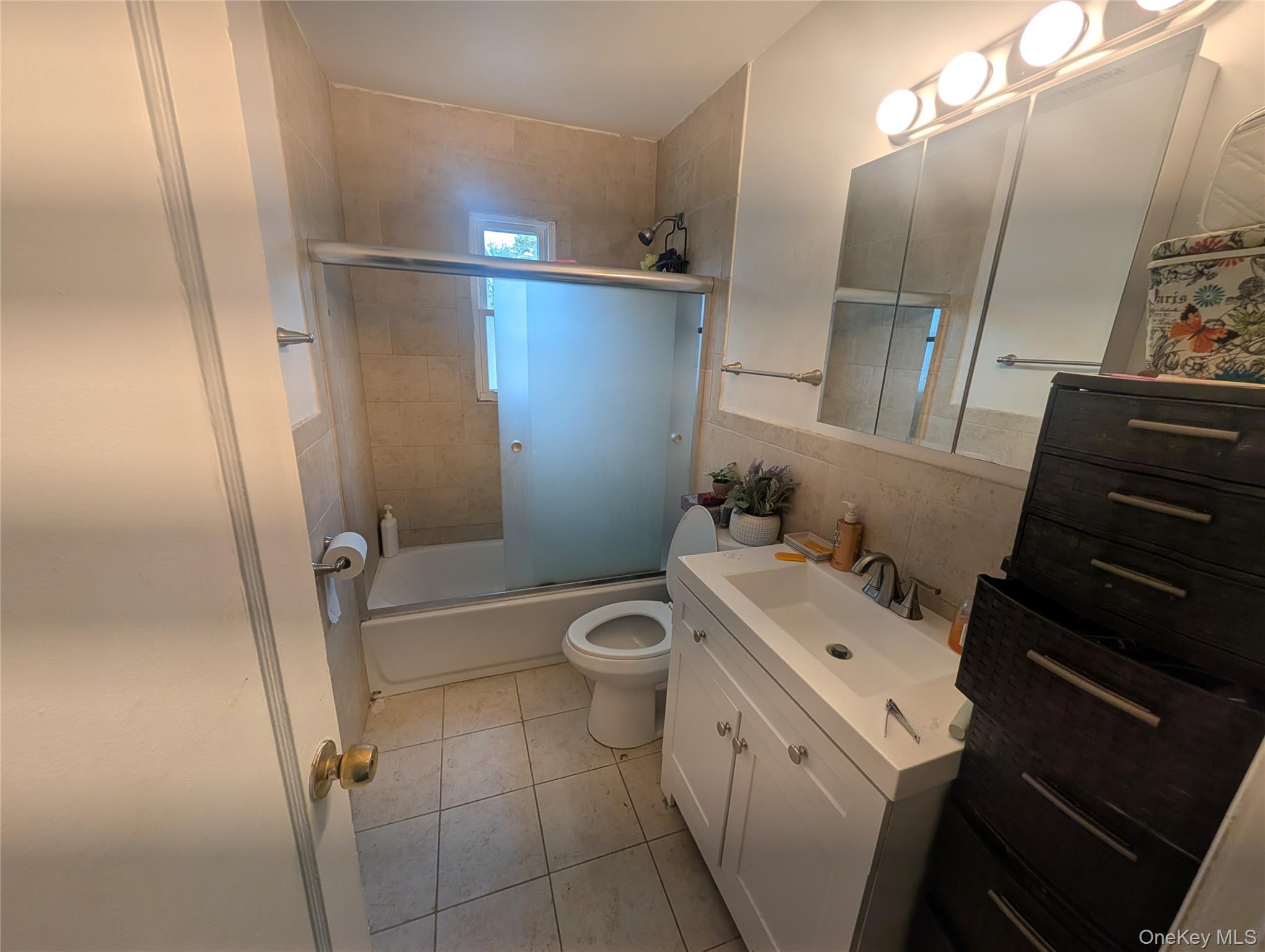 39 State Street Valley Stream, NY 11580 - Photo 6 of 7 a bathroom with a toilet a sink and a mirror