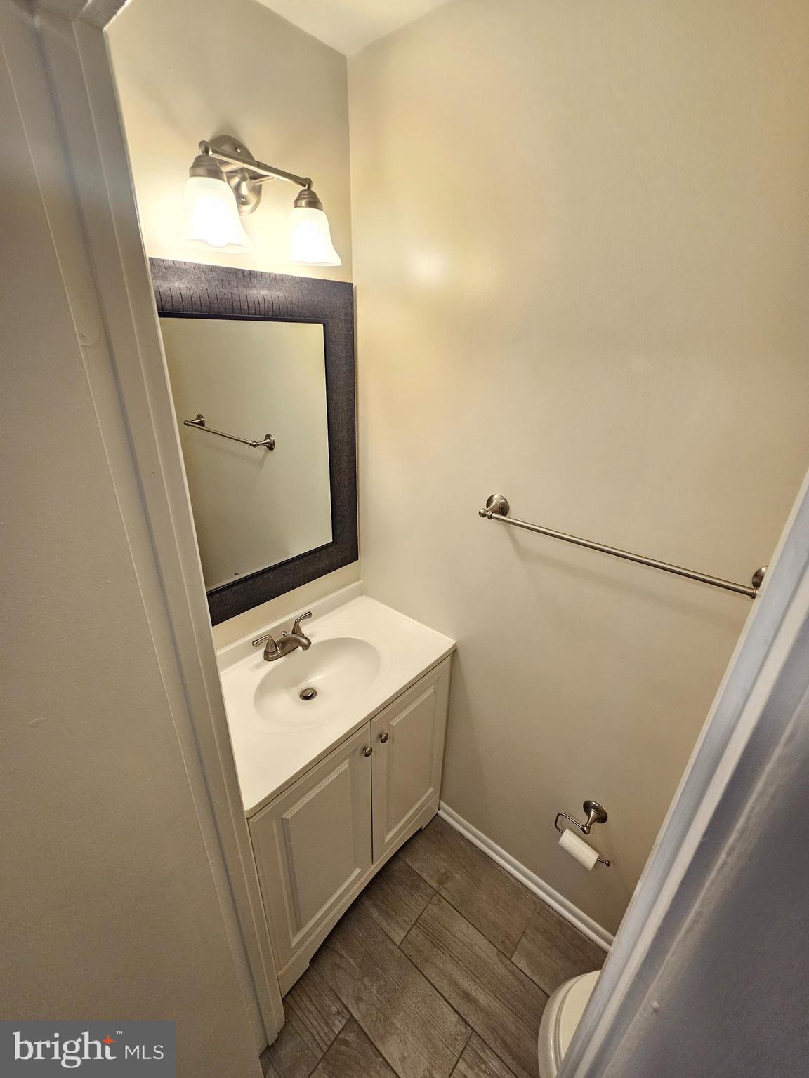 17445 Hoskinson Road Poolesville, MD 20837 - Photo 16 of 37 a bathroom with a granite countertop sink and a mirror