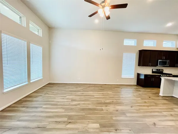 a view of kitchen with sink and microwave