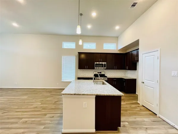a kitchen with stainless steel appliances a refrigerator and a stove