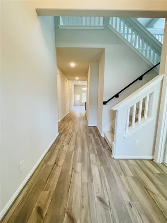 a view of a hallway with wooden floor
