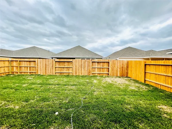 a view of an house with backyard and balcony