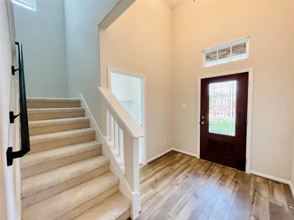 a view of an entryway with wooden floor