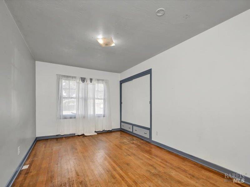 315 White Cottage Road North Angwin, CA 94508 - Photo 12 of 36 an empty room with wooden floor and windows