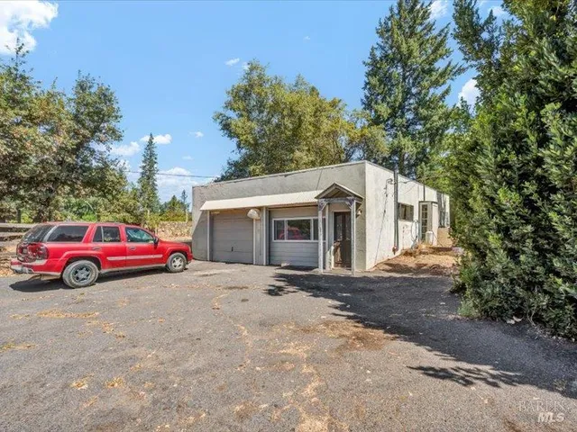 a car parked in front of a white house