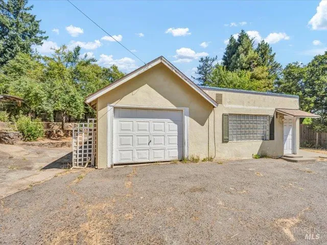a view of a house with a yard and garage