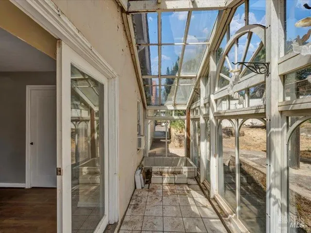 a view of an entryway with wooden floor