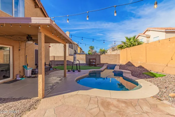 a swimming pool with outdoor seating