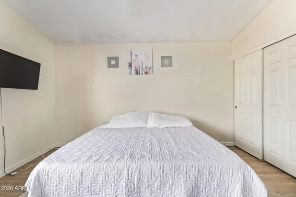 a bedroom with a bed and a flat screen tv