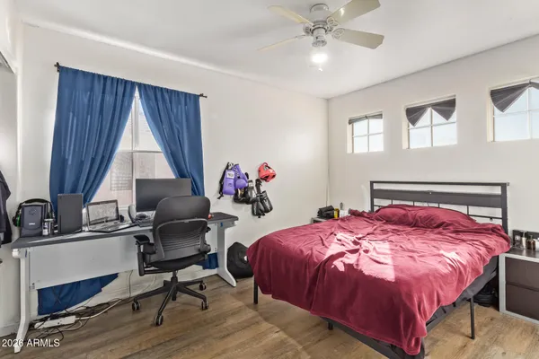 a bedroom with a bed and a chandelier