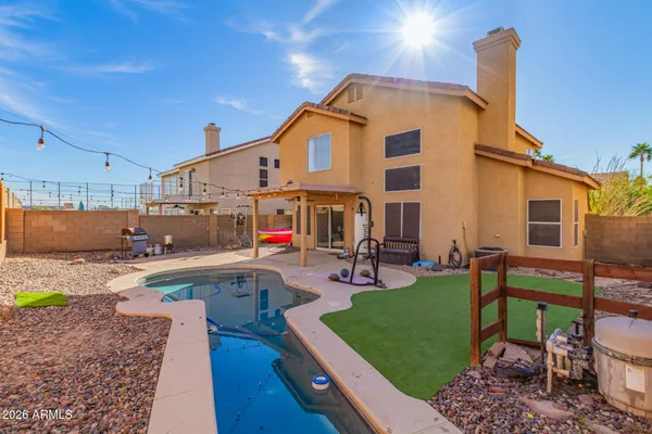 a view of a backyard with plants and a patio