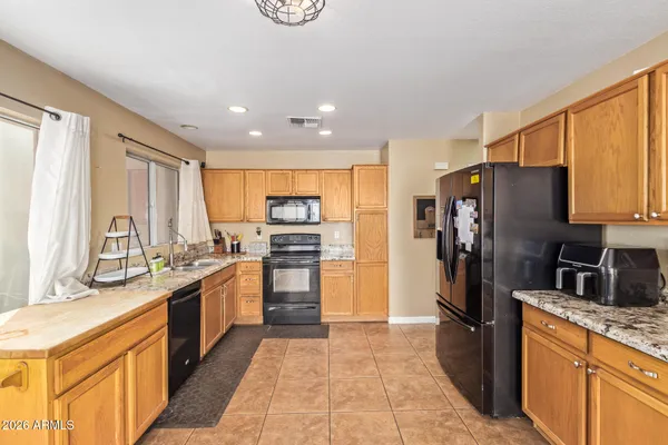 a kitchen with stainless steel appliances granite countertop a refrigerator and a sink